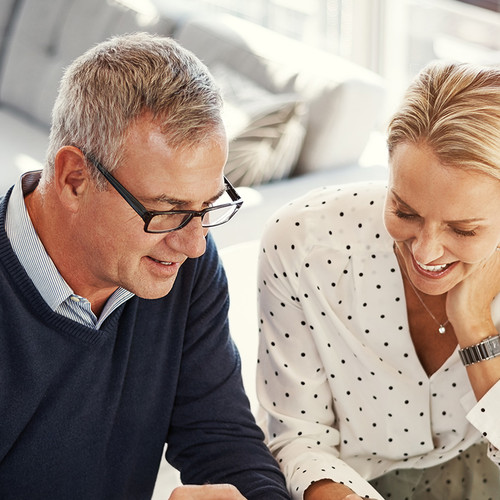 Couple smiling looking at documents