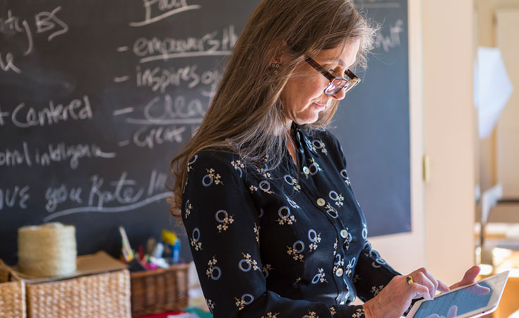 female teacher working on an ipad