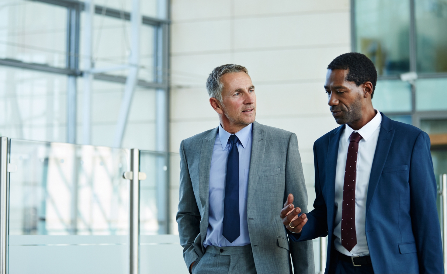 two male professionals walking and talking
