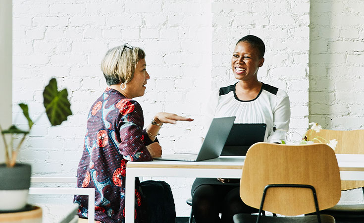 female advisor sitting and talking with a female client
