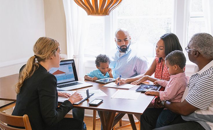 family sitting down with a financial advisor