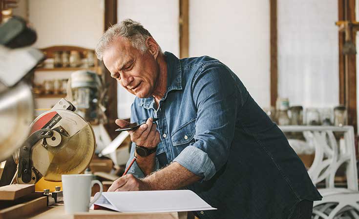 older man working in a woodshop