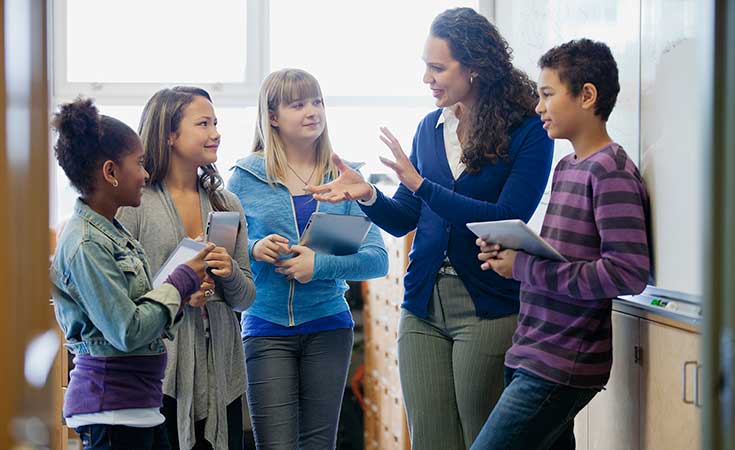 teacher talking to a group of students